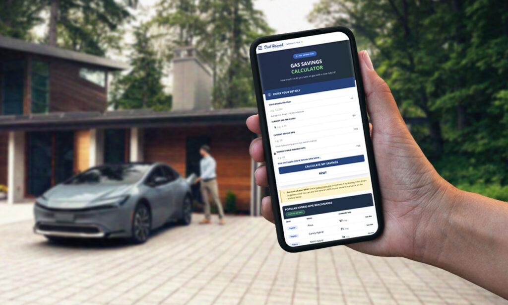 Hand holding a smartphone displaying Dick Hannah’s gas savings calculator beside a hybrid car in a driveway.