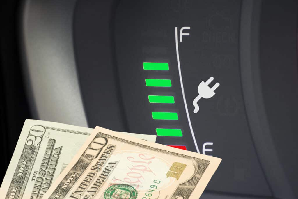 An electric car, charging indicator and dollar bills