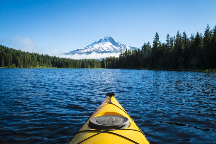 front of a canoe looking at mount hood from in a lake