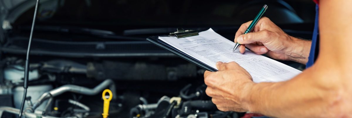 Car technician inspecting car to make sure there are no mechanical problems with it before sale