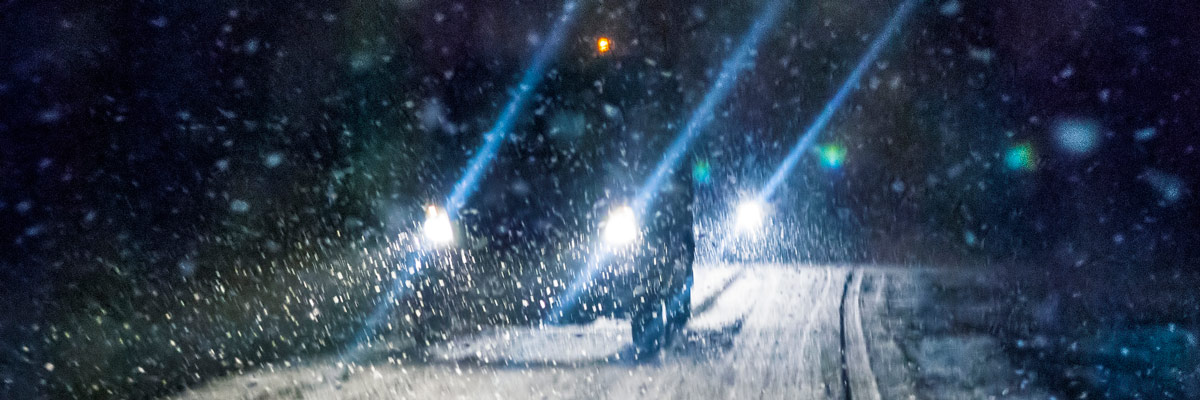 Car driving during winter snowstorm. Motion blur.