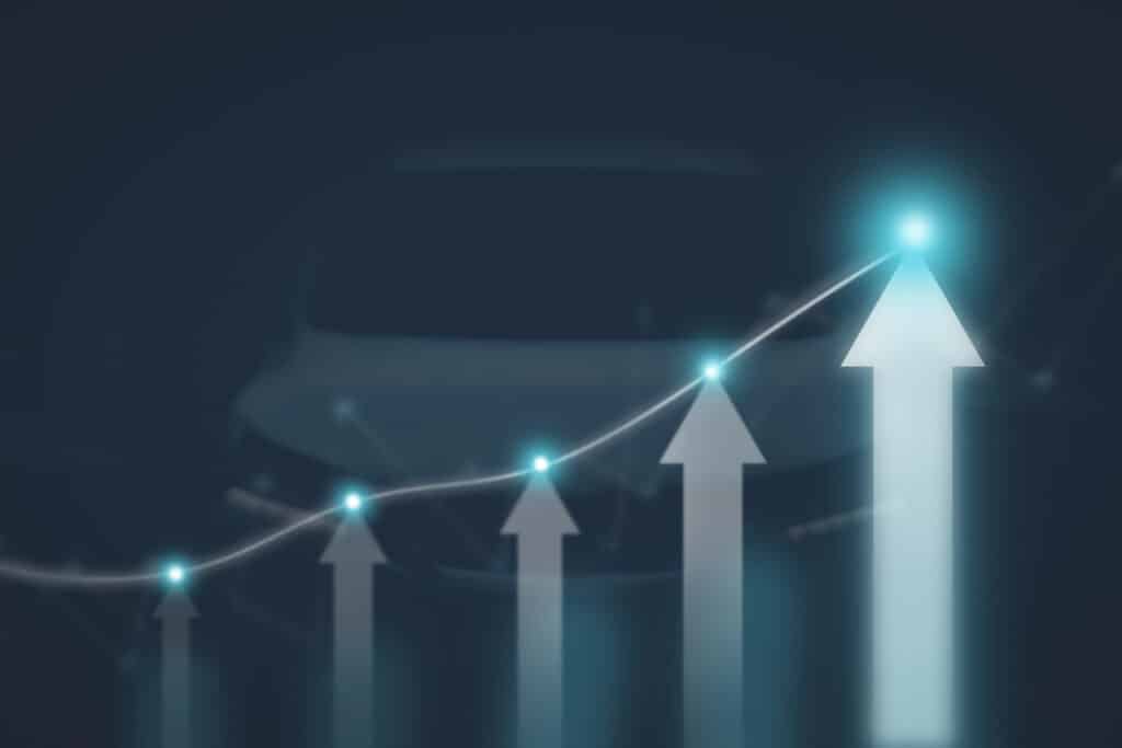 The arrow graph automotive future growth plan with glowing points and vehicle blurred on background, Automotive business concept