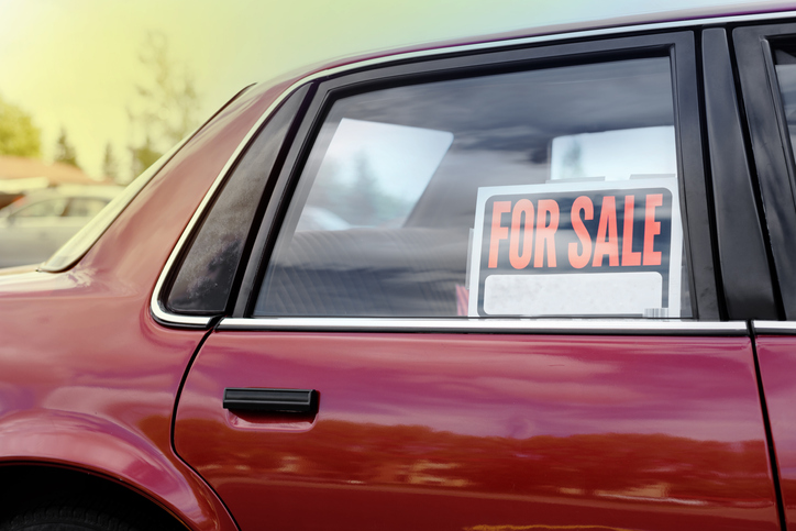 A used car with a ford sale sign in the window