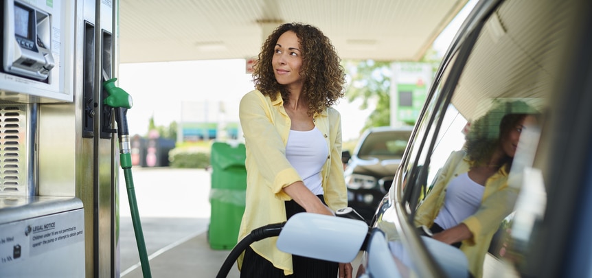 Woman putting regular gasoline into her car